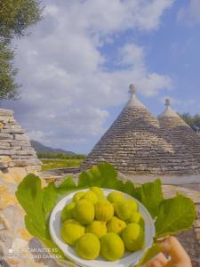 a bowl of lemons on a plate on a table at Masseria Calò in Monopoli