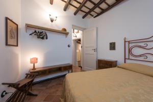 a bedroom with a bed and a bench in a room at Antica Fortezza Villa Fontana in Valderice +47 photos