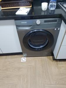 a washing machine sitting on the floor in a kitchen at appartement NADOR wifi gratuit clima mobile in Selouane