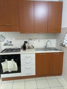 a kitchen with a stove and a sink at La villetta 2.0 in Rende