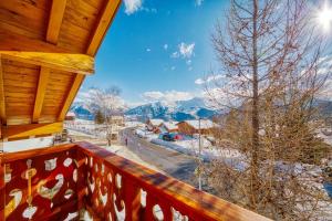 a view from the balcony of a cabin with snow covered mountains at Chalet l'Hermine in La Toussuire