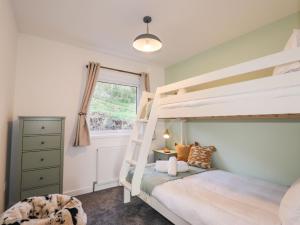 a bedroom with two bunk beds and a window at The Lookout in Saasaig