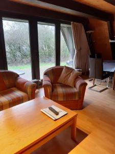 a living room with two couches and a coffee table at Ferienhaus Winnetou 114 in Waldbrunn