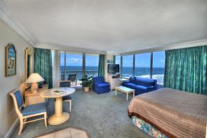 a hotel room with a bed and a view of the ocean at Daytona Beach Resort Condos in Daytona Beach