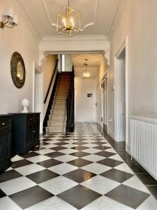 a hallway with a black and white checkered floor at Bodorgan Inn By Birch Stays in Bodorgan