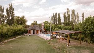 a house with a swimming pool in a yard at Jumani Cabañas in San Rafael