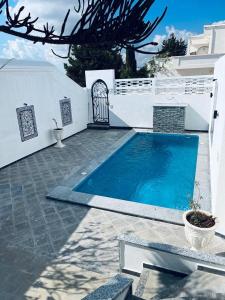 a swimming pool in the backyard of a house at Maison du Cap Bon,Ben Hamida in El Haouaria