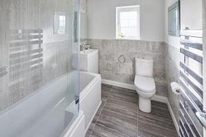 a bathroom with a toilet and a tub and a sink at Host & Stay - Benton Road in Newcastle upon Tyne