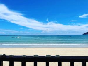 a bench on a beach with a view of the ocean at Tiongman Scubadive & Lodge in Tioman Island
