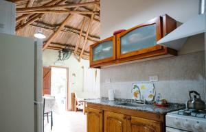 a kitchen with a sink and a stove top oven at Jumani Cabañas in San Rafael