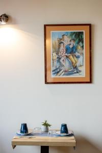 a painting on a wall above a table at Hôtel Lastiry in Sare