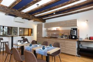 a dining room with two tables and a kitchen at Hôtel Lastiry in Sare