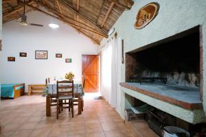 a living room with a fireplace and a table and chairs at Jumani Cabañas in San Rafael +43 photos