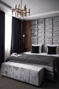 a bedroom with a large bed with a large headboard at Åsby Hotell in Hallstahammar
