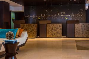 a living room with a couch and a table at Renaissance Barcelona Hotel in Barcelona