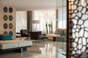 a living room with a couch and a table at Renaissance Barcelona Hotel in Barcelona