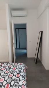 a white room with a bed and a hallway at La casa di Piazzale Ardigò in Rome