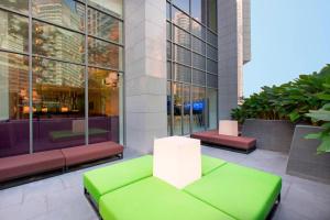 a green couch sitting in front of a building at Aloft Kuala Lumpur Sentral in Kuala Lumpur