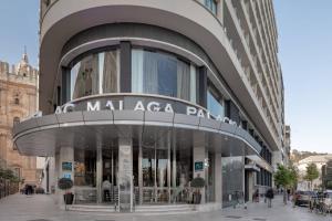 a large building with a sign that reads malaga park at AC Hotel Málaga Palacio by Marriott in Málaga