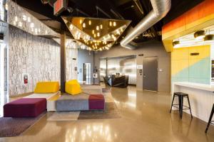 a lobby with a couch and a table at Aloft Austin Airport in Austin