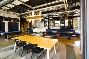a dining room with a ping pong table and chairs at Aloft Austin Airport in Austin