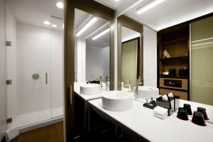 a bathroom with two sinks and a large mirror at Aloft Austin Airport in Austin
