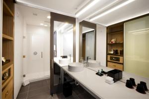 a bathroom with two sinks and a large mirror at Aloft Austin Airport in Austin