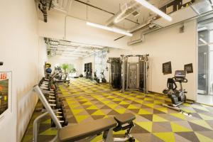 a gym with treadmills and elliptical machines at Aloft Austin Airport in Austin