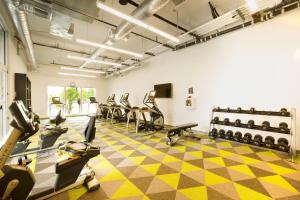 a gym with treadmills and elliptical machines at Aloft Austin Airport in Austin