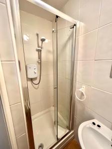 a bathroom with a shower and a toilet and a sink at The Brunswick Hotel in Bridlington