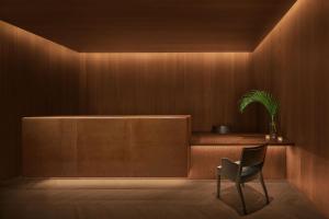 a chair in a room with a wooden wall at The Madrid EDITION in Madrid