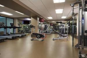 a gym with several treadmills and machines at Dallas/Fort Worth Airport Marriott in Irving