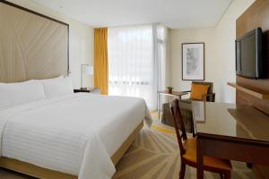 a hotel room with a bed and a flat screen tv at Lisbon Marriott Hotel in Lisbon