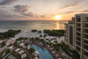 an aerial view of a resort with a pool and the ocean at The Ritz-Carlton, Aruba in Palm-Eagle Beach