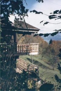 a building on top of a hill with a bridge at Chalet Hüsli in Giswil