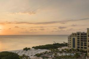 a view of a hotel and the ocean at sunset at The Ritz-Carlton, Aruba in Palm-Eagle Beach