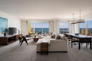 a living room with a couch and a dining room at The Ritz-Carlton, Aruba in Palm-Eagle Beach