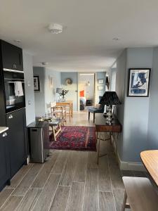 a living room with a kitchen and a dining room at Sandpiper in Fowey