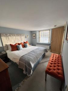 a bedroom with a large bed and a window at Sandpiper in Fowey