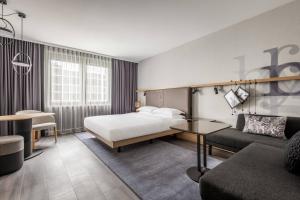 a hotel room with a bed and a couch at Frankfurt Airport Marriott Hotel in Frankfurt/Main