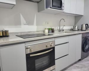 a kitchen with a sink and a stove at Selena Bay Resort - Luxury 2 Bed Apt with Private Beach in Hurghada