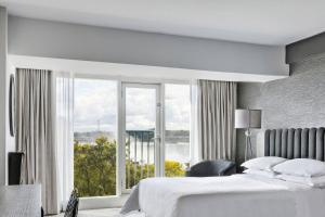 a bedroom with a bed and a large window at Sheraton Fallsview Hotel in Niagara Falls