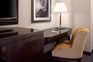 a desk in a hotel room with a lamp and a chair at Sheraton Fallsview Hotel in Niagara Falls