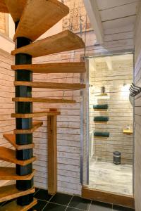 a wooden spiral staircase in a bathroom with a shower at La Maison in La Chapelle-Saint-Martin-en-Plaine