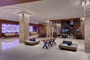 a lobby of a hotel with a table and chairs at JW Marriott Austin in Austin