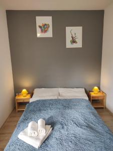 a bedroom with a bed with towels and two lamps at Pokoje Pod Gruszą -osobne wejścia in Kudowa-Zdrój