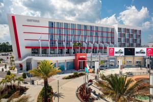 a large white building with palm trees in front of it at The Daytona, Autograph Collection in Daytona Beach