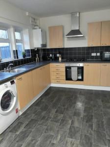 a kitchen with a washer and a washing machine at Contractor's Haven- 4-Bedroom House with Free Parking, Super Fast WiFi, Fran Properties in Aylesbury, Pets are Welcome in Buckinghamshire