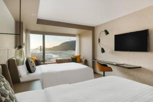 a hotel room with two beds and a flat screen tv at Budapest Marriott Hotel in Budapest