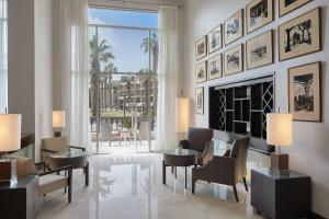 a living room with a fireplace and tables and chairs at Marriott Mena House, Cairo in Cairo